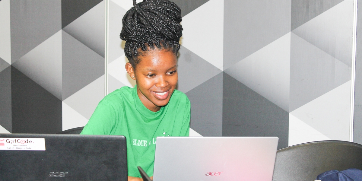 A young woman coding at the AI Mashup 
