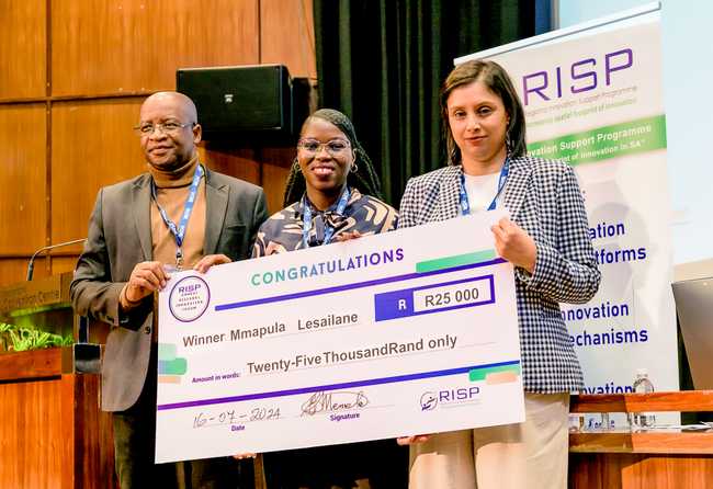 Mmapula Lesailane with the voucher she won 